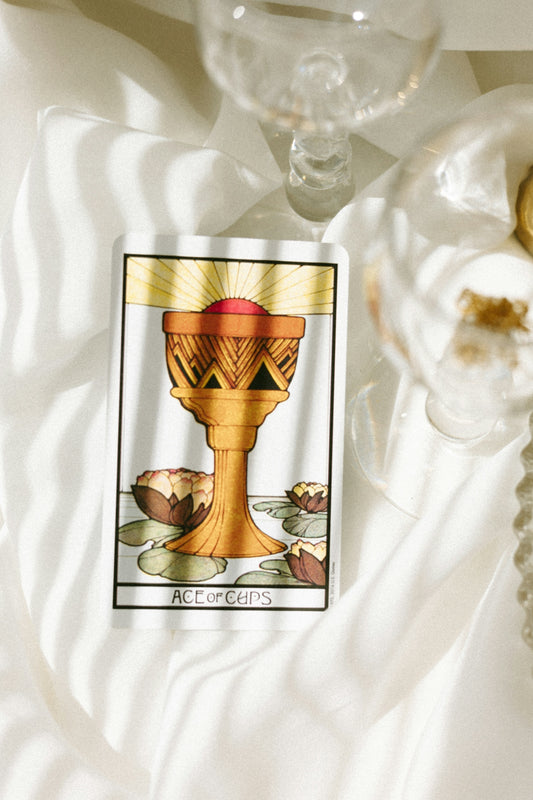 a tarot card sitting on top of a white cloth